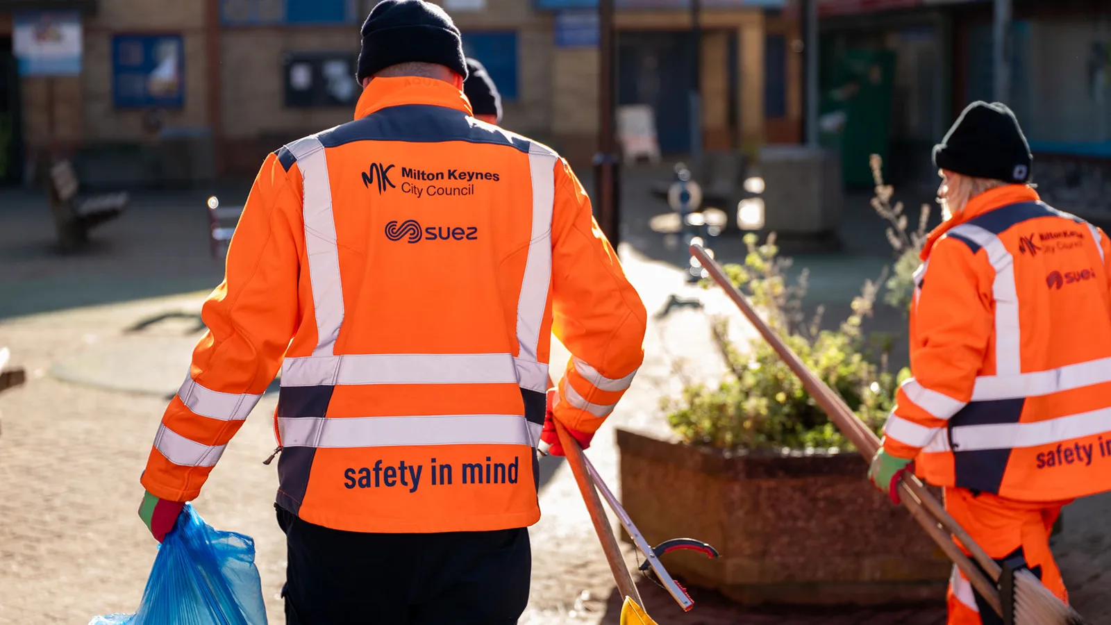 SUEZ street cleaning crew in Milton Keynes City Council and SUEZ uniforms.